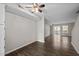 Living room with a ceiling fan, base molding, an electrical outlet, wood-look flooring, and a sliding glass door at 128 Schultz St, Chapel Hill, NC 27514