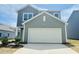 Charming two-story home featuring a two-car garage, landscaped front yard, and classic curb appeal at 129 N Keatts Winner Ct, Wilson's Mills, NC 27520