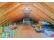 Spacious attic storage area with exposed wood beams, offering potential for finishing at 1408 Bridgeport Dr, Raleigh, NC 27615