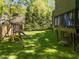 Green backyard featuring play equipment and a raised playhouse on a grassy lawn at 1408 Bridgeport Dr, Raleigh, NC 27615