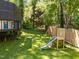 Spacious backyard with play equipment and a raised playhouse at 1408 Bridgeport Dr, Raleigh, NC 27615