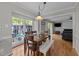 Dining room with hardwood floors, large windows, and an adjacent living area at 1408 Bridgeport Dr, Raleigh, NC 27615