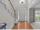 Bright foyer with hardwood floors, a staircase, and a view into the living area at 1408 Bridgeport Dr, Raleigh, NC 27615