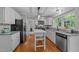 Bright kitchen with white cabinets, granite countertops, and stainless steel appliances at 1408 Bridgeport Dr, Raleigh, NC 27615