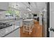 Open-concept kitchen with an island, granite counters, and easy access to the dining and living areas at 1408 Bridgeport Dr, Raleigh, NC 27615