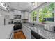 Bright kitchen with white cabinets, granite countertops, and stainless steel appliances at 1408 Bridgeport Dr, Raleigh, NC 27615