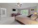 Spacious primary bedroom features a large window, soft carpet, and ceiling fan at 1408 Bridgeport Dr, Raleigh, NC 27615