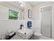 Bathroom featuring white tile, granite counter, and walk-in shower at 1701 Pinedale Dr, Raleigh, NC 27603