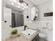 Bathroom features a vanity sink with granite countertop and decorative light fixture over a large mirror at 1701 Pinedale Dr, Raleigh, NC 27603