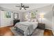 Comfortable bedroom with a ceiling fan and natural light from two windows at 1701 Pinedale Dr, Raleigh, NC 27603