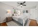 Bedroom features a ceiling fan, a large window, and stylish decor at 1701 Pinedale Dr, Raleigh, NC 27603