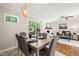 Open dining area flows to living room with fireplace, with outdoor views at 1701 Pinedale Dr, Raleigh, NC 27603