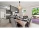 Dining area with modern light fixture and view into kitchen with granite countertops at 1701 Pinedale Dr, Raleigh, NC 27603