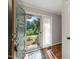 The entryway features a glass storm door leading to a hardwood floor and neutral color walls at 1701 Pinedale Dr, Raleigh, NC 27603
