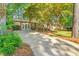 Charming single-story brick house with a well-manicured lawn, mature tree, and long driveway, offering curb appeal at 1701 Pinedale Dr, Raleigh, NC 27603