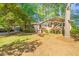 Charming brick home with a well-maintained lawn, a mature tree, and manicured flowerbeds at 1701 Pinedale Dr, Raleigh, NC 27603