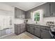 Bright kitchen with gray cabinets, granite counters, and a window providing natural light at 1701 Pinedale Dr, Raleigh, NC 27603