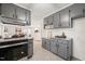 Well-lit kitchen with gray cabinetry, granite countertops, and stainless steel oven at 1701 Pinedale Dr, Raleigh, NC 27603