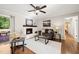 Cozy living room featuring a fireplace, hardwood floors, neutral color scheme, and abundant natural light at 1701 Pinedale Dr, Raleigh, NC 27603