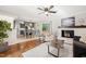 Open-concept living and dining area with fireplace, hardwood floors, and a view of the modern kitchen at 1701 Pinedale Dr, Raleigh, NC 27603