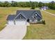 Aerial view of a home with large yard space, well manicured lawn, and a three car garage at 194 Spring Hill Church Rd, Lillington, NC 27546