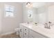 Bright bathroom featuring a double vanity, white cabinets and modern fixtures at 194 Spring Hill Church Rd, Lillington, NC 27546