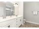 Bathroom featuring double sink vanity, white cabinets, and a framed mirror at 194 Spring Hill Church Rd, Lillington, NC 27546