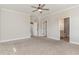 Carpeted main bedroom with multiple closets, a ceiling fan, and ensuite bathroom at 194 Spring Hill Church Rd, Lillington, NC 27546