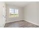 Neutral bedroom with hardwood floors, one window for natural light, and simple décor at 194 Spring Hill Church Rd, Lillington, NC 27546