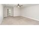 Spacious bedroom with neutral carpeting, ceiling fan, and natural light at 194 Spring Hill Church Rd, Lillington, NC 27546