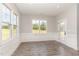 Dining area with wainscoting detail, multiple windows for natural light, and hardwood floors at 194 Spring Hill Church Rd, Lillington, NC 27546