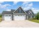 Charming two-story home with a three-car garage, stone accents, and well-manicured lawn at 194 Spring Hill Church Rd, Lillington, NC 27546