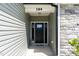 Close up of home's front door featuring stone accents and a welcome mat at 194 Spring Hill Church Rd, Lillington, NC 27546