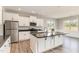 Modern kitchen with stainless steel appliances, granite countertops, and a center island at 194 Spring Hill Church Rd, Lillington, NC 27546