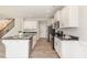 Modern kitchen featuring stainless steel appliances, granite countertops, and white cabinetry at 194 Spring Hill Church Rd, Lillington, NC 27546