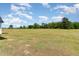 Expansive grassy field with mature trees, creating a peaceful and private setting at 194 Spring Hill Church Rd, Lillington, NC 27546