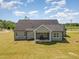 Back exterior of home with a covered patio and a spacious backyard at 194 Spring Hill Church Rd, Lillington, NC 27546