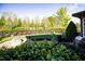 Landscaped backyard with a stone fire pit and lush green grass at 20 Al Aqua Dr, Durham, NC 27707