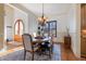 Cozy dining room with a round table, upholstered chairs, and a decorative chandelier at 20 Al Aqua Dr, Durham, NC 27707