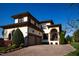 Expansive home with a two-car garage and beautiful landscaping set against a vivid blue sky at 20 Al Aqua Dr, Durham, NC 27707