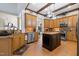 Spacious kitchen featuring a central island, stainless appliances and adjacent breakfast area at 20 Al Aqua Dr, Durham, NC 27707