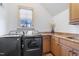 Functional laundry room with side-by-side machines, a window, and plenty of counter space at 20 Al Aqua Dr, Durham, NC 27707