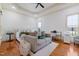 Bright main bedroom features a seating area, desk, and beautiful hardwood floors at 20 Al Aqua Dr, Durham, NC 27707