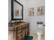 Elegant powder room with a granite vanity, decorative mirror, and classic fixtures at 20 Al Aqua Dr, Durham, NC 27707