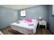 Well-lit bedroom, featuring wood floors, a metal bed frame, and soft pink accents creating a cozy and relaxing retreat at 2006 Waters Dr, Raleigh, NC 27610