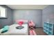 Comfortable bedroom with natural light, light grey walls, wood floors, and cheerful pink accents create a bright space at 2006 Waters Dr, Raleigh, NC 27610