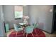 Cozy dining area featuring a glass table, velvet chairs, and a stylish, modern light fixture at 2006 Waters Dr, Raleigh, NC 27610