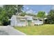 Beautiful home featuring well-kept lawn, driveway, and a vibrant, eye-catching blue front door at 2006 Waters Dr, Raleigh, NC 27610