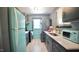 Well-equipped kitchen featuring custom-colored appliances and sleek countertops at 2006 Waters Dr, Raleigh, NC 27610