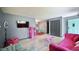 Eclectic living room showcases playful decor, a pink sofa, and an open layout leading to the dining area at 2006 Waters Dr, Raleigh, NC 27610